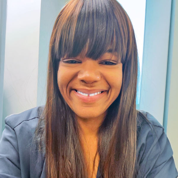 Female African American student in gray scrubs