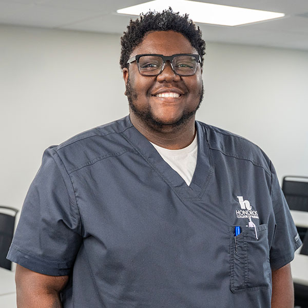 African American Male Nursing student in gray scrubs in a classroom