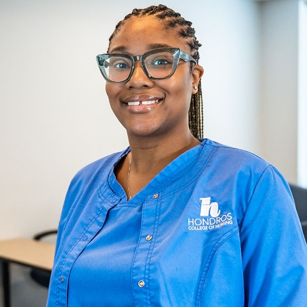 African American female nursing student in blue scrubs