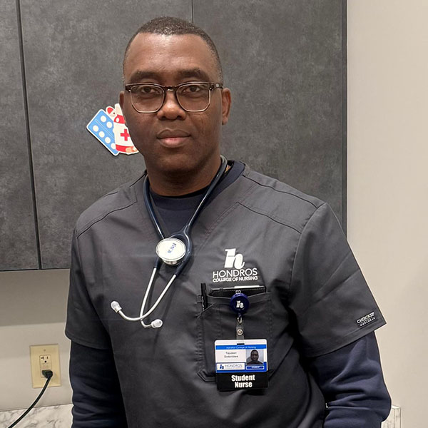 Male student nurse in gray scrubs