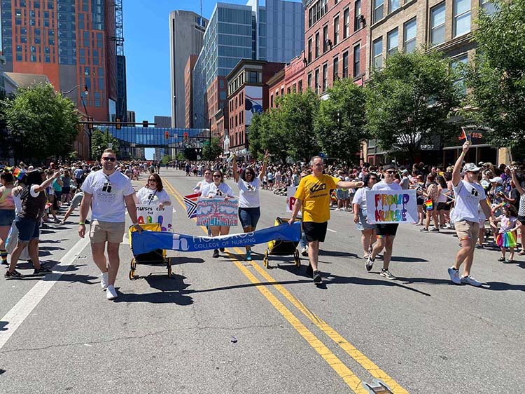 Walking With Sign At Pride Festival
